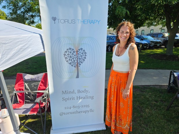 Jamie Kruse of Batavia, owner of Torus Therapy, takes part in the WellBatavia Festival Saturday at the Peg Bond Center in Batavia that focused on health and wellness. (David Sharos / For The Beaon-News)