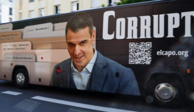 A bus with an image of Spain's prime minister, Pedro Sánchez, with the word "Corrupt" drives by his party headquarters shortly before he was scheduled to hold a press conference on June 12, 2025.