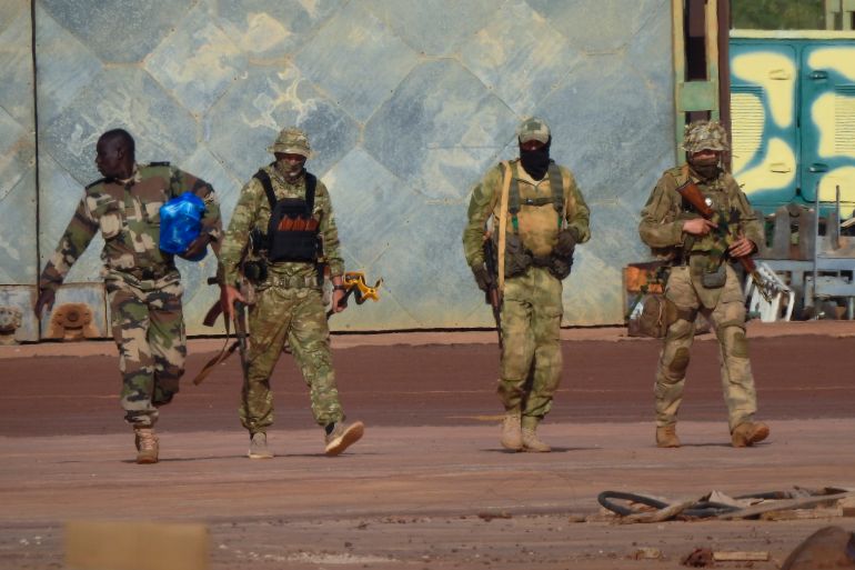 Three Russian mercenaries in military fatigues.