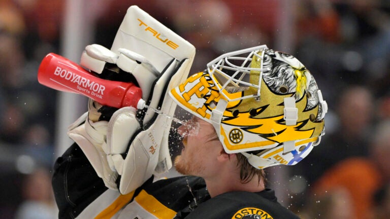 Boston Bruins goaltender Joonas Korpisalo cools off during a stoppage in play during the first period of an NHL hockey game against the Anaheim Ducks, Wednesday, March 26, 2025, in Anaheim, Calif.