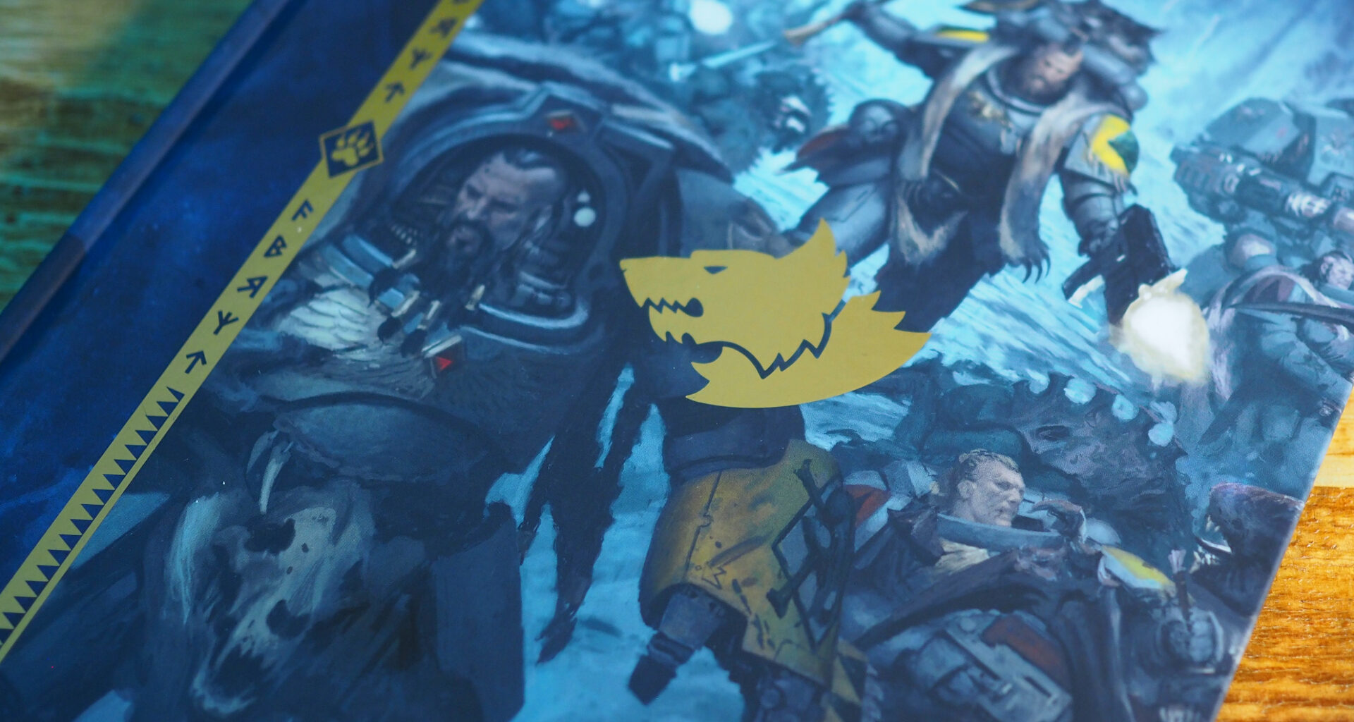 The cover of a Space Wolves Codex on a wooden surface