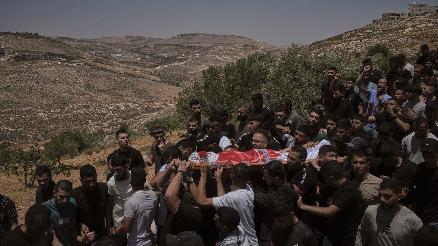 West Bank: Israeli settlers rampage at a military base | AP News