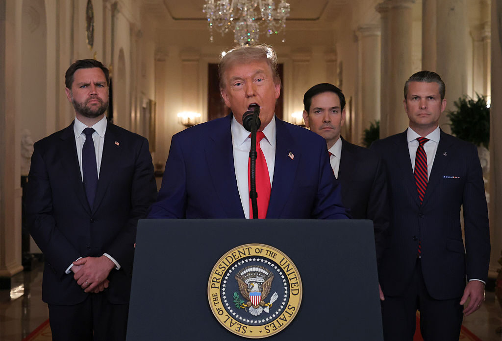 President Donald Trump, flanked, from left, by Vice President JD Vance, Secretary of State Marco Rubio and Defense Secretary Pete Hegseth, addresses the nation from the White House on Saturday. (Carlos Barria - Pool/Getty Images)