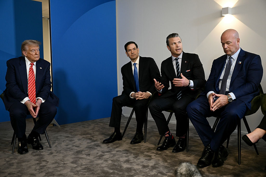 President Donald Trump listens as Defense Secretary Pete Hegseth, second from right, addresses reporters Wednesday at the NATO summit. Also pictured are Secretary of State Marco Rubio, second from left, and U.S. Ambassador to NATO Matthew Whitaker. (Brendan Smialowski/Pool/Getty Images)