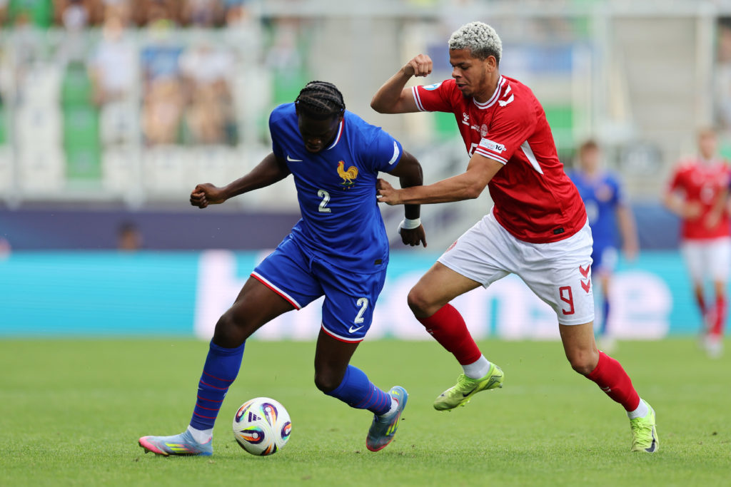 Willam Osula of Denmark U21s trying to tackle Castello Lukeba of France U21s.