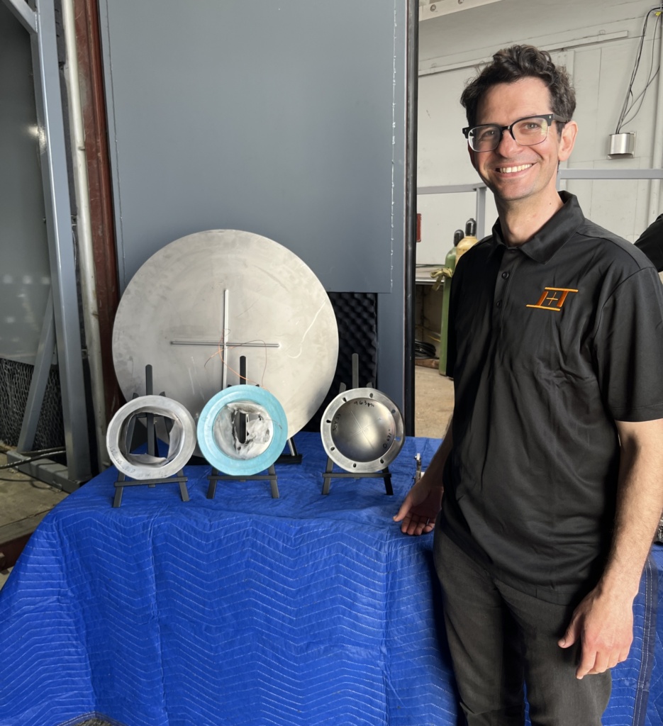CTO Nato Saichek with burst discs the company has developed to precisely accelerate payloads down the barrel of its guns. Image: Tim Fernholz