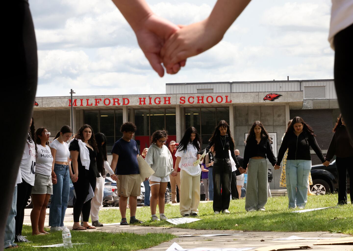  Students prayed outside of Milford High School after walking out of school to protest the detention of Marcelo Gomes Da Silva in Milford on June 2.
