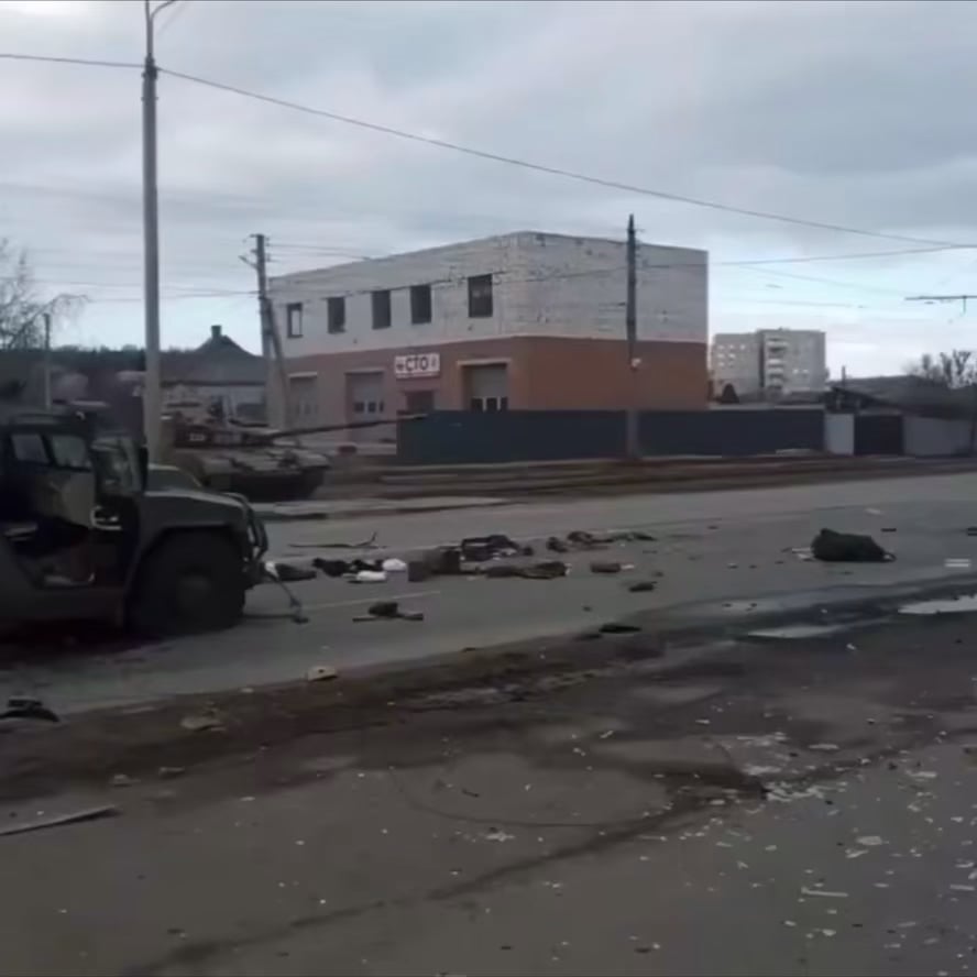 Ukrainian soldiers and police officers watch as a T-64B1VK tank targets School No. 134. After the strike, the fighters will proceed with a clearing operation. Kharkiv city, Kharkiv region.
