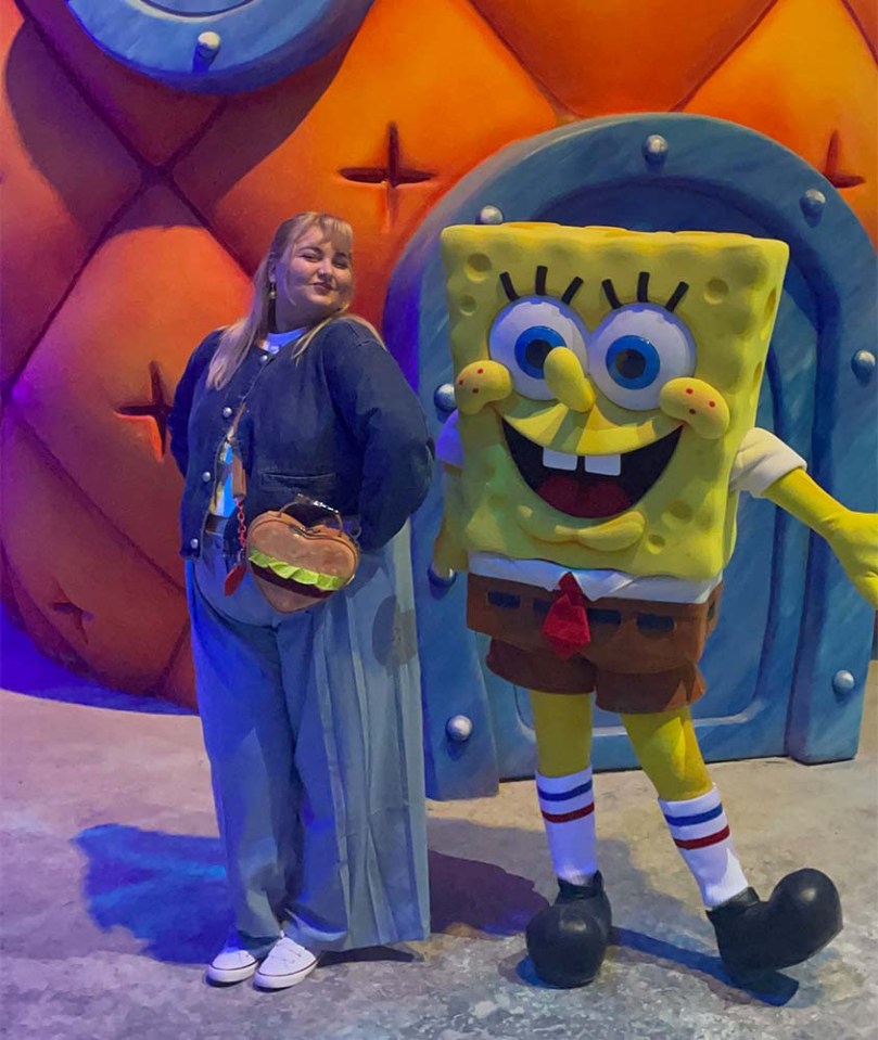 A person posing with a Spongebob Squarepants character.