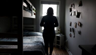 Marcelo Gomes da Silva’s mother poses for a photo in her son’s bedroom in Milford on Monday. Gomes was detained by ICE on his way to volleyball practice.