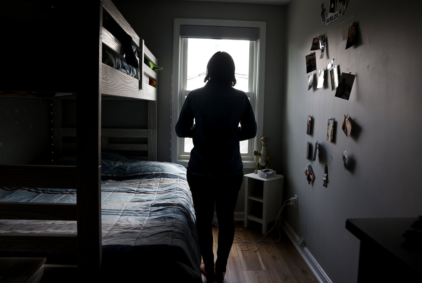 Marcelo Gomes da Silva’s mother poses for a photo in her son’s bedroom in Milford on Monday. Gomes was detained by ICE on his way to volleyball practice.