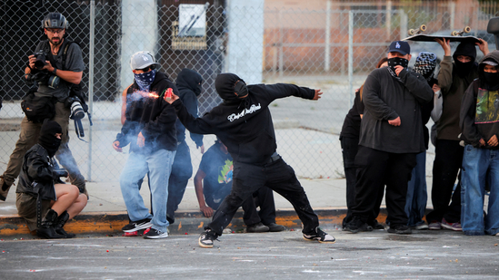 A protester throws a firework during a standoff between police and protesters following multiple detentions by Immigration and Customs Enforcement (ICE), in the Los Angeles County city of Paramount, California, U.S., June 7, 2025. (REUTERS)