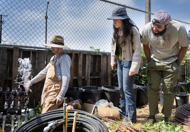 Landscape contractor Michael Sherman teaches a lesson on irrigation at...