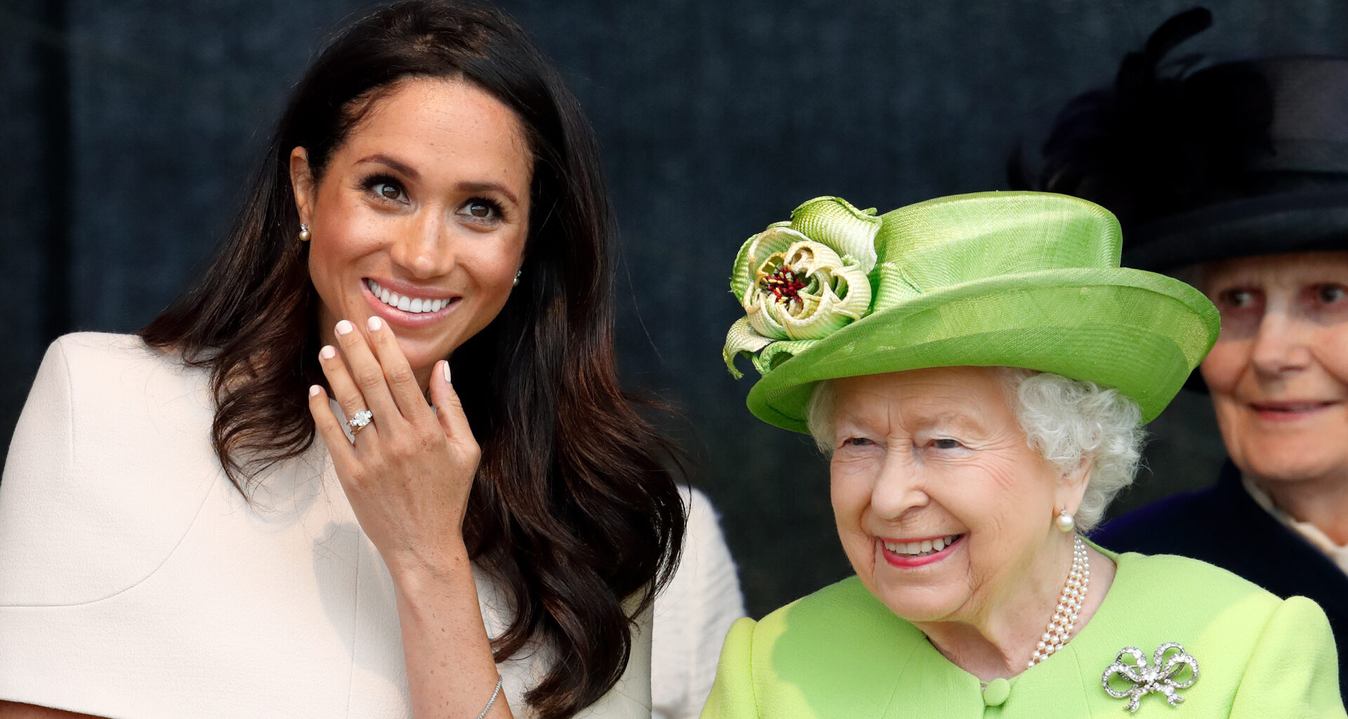Meghan Markle wears a cream dress and attends a joint engagement with Queen Elizabeth, who wears a bright green coat, on June 14, 2018