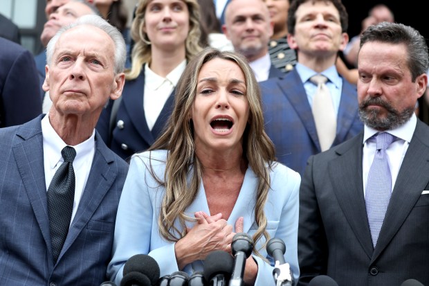 Karen Read shouts over the cheers from supporters outside the Dedham courthouse after being set free by a jury. (Stuart Cahill/Boston Herald)