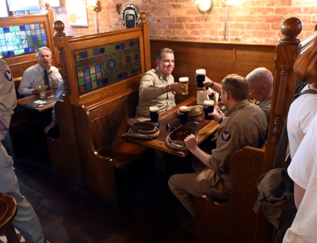 British and American reenactors from the World War II Weekend at Reading Regional Airport toast at the Ugly Oyster Pub in downtown Reading on Friday, June 6, 2025. (BILL UHRICH/READING EAGLE)