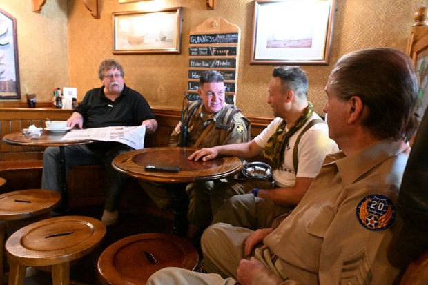 British and American reenactors from the World War II Weekend at Reading Regional Airport interact with a civilian at the Ugly Oyster Pub in downtown Reading on Friday, June 6, 2025. (BILL UHRICH/READING EAGLE)