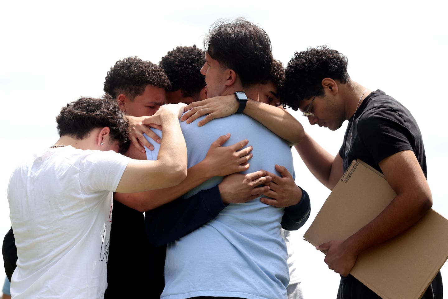  Students embraced outside of Milford High School after walking out of school to protest the detention of Marcelo Gomes Da Silva in Milford on June 2.