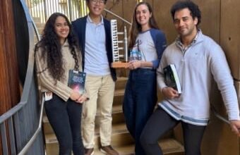 Members of the SLSS stand in the staircase by the Law School terrace