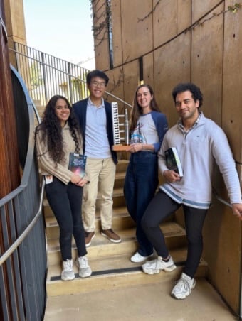 Members of the SLSS stand in the staircase by the Law School terrace