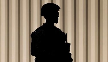 A Marine stands guard outside the Wilshire Federal Building in Los Angeles.