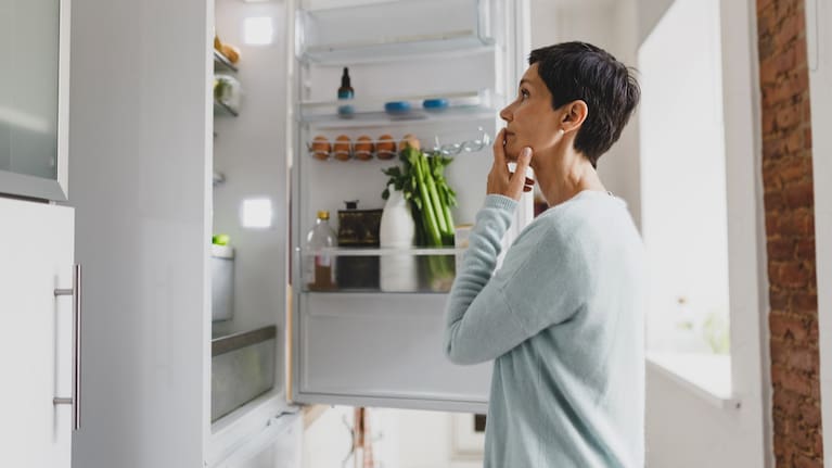 A woman ponders what to eat. 
