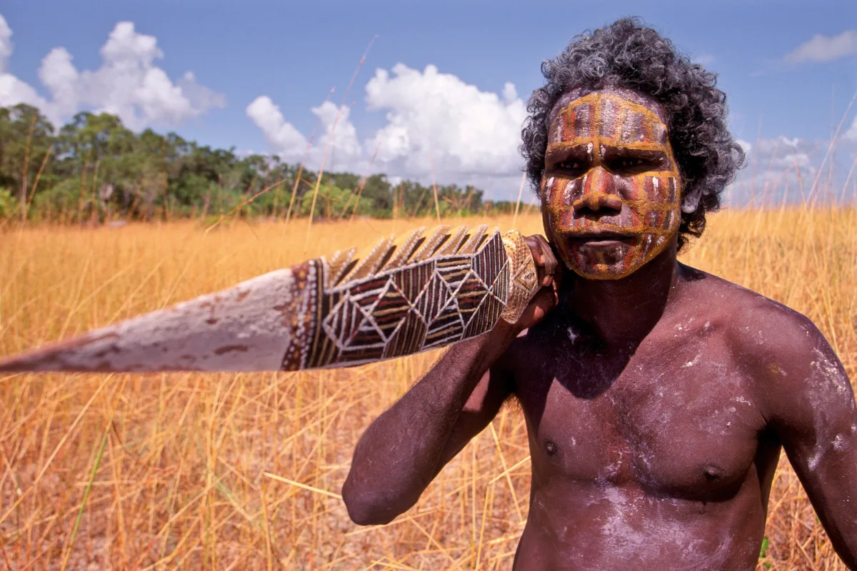 Photo of an Aborigine hunter holding a spear.