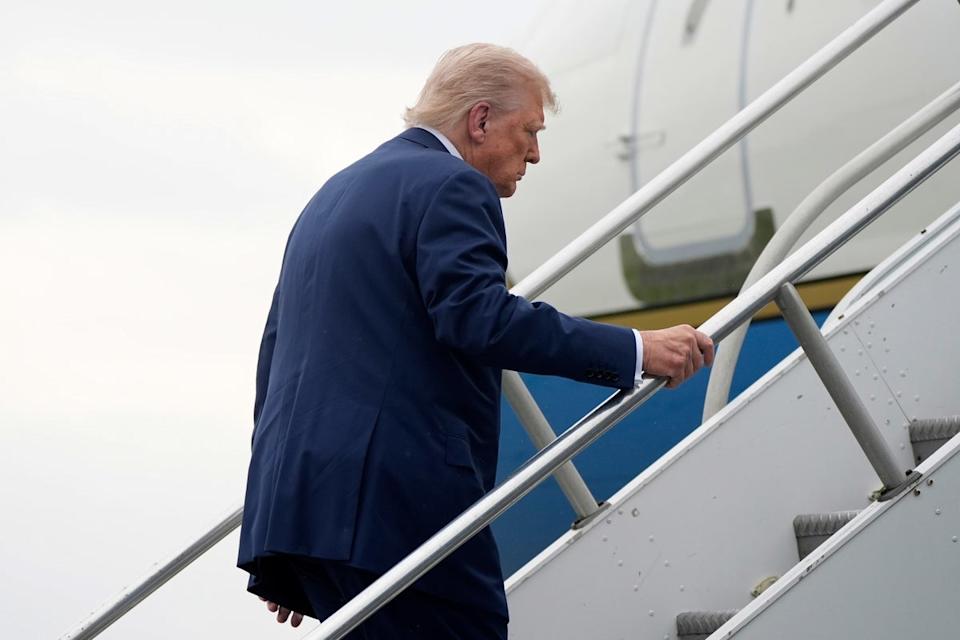 Trump stumbled as he made his way up the stairs of Air Force One on Sunday (AP)
