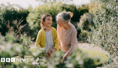 Older woman with a young girl in a garden.