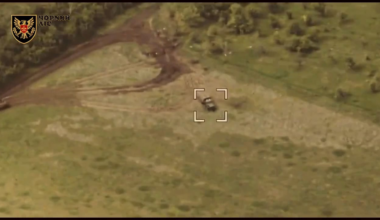 A Ukrainian reconnaissance drone of the Black Forest brigade's operators monitors the destruction by a GMLRS missile from the HIMARS MLRS of a 2C7 Pion self-propelled gun and an ammunition truck. June 2025.