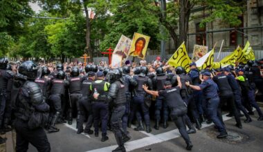 Moldovan police forces and Carabinieri gendarmes push back anti-LGBT protesters as a Pride parade takes place in Chișinău on June 15, 2025.