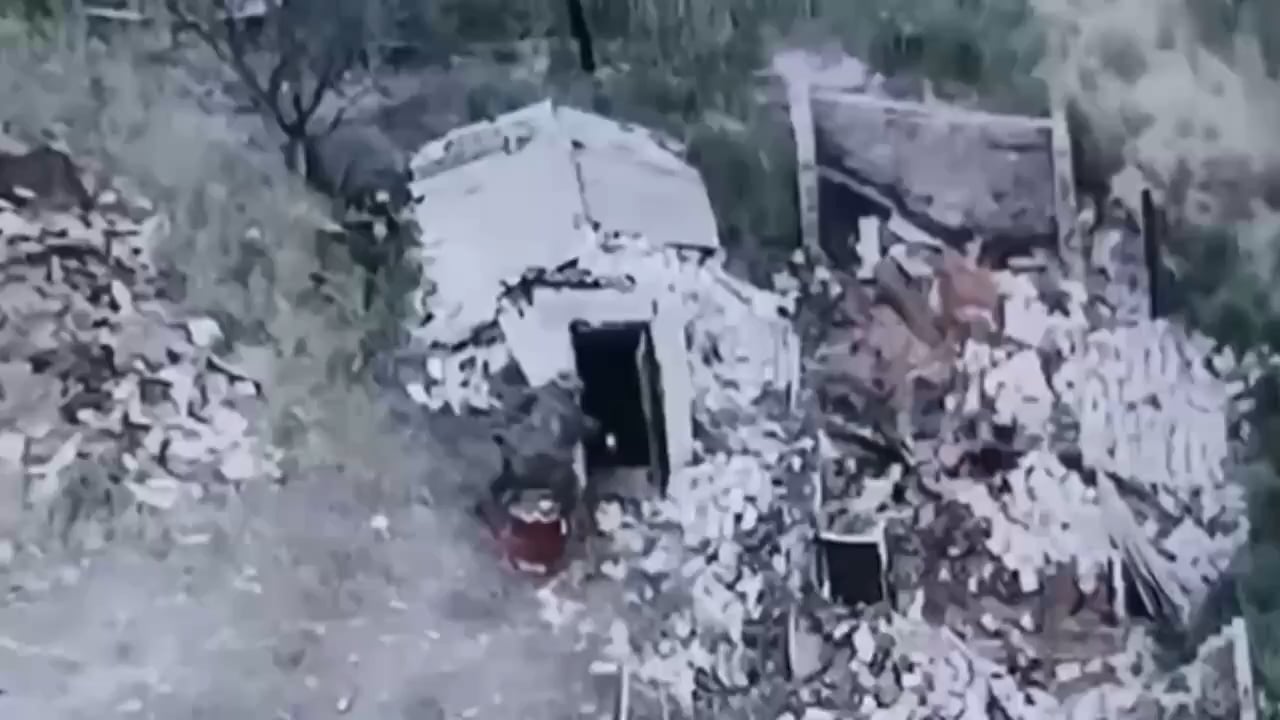 An Ukrainian soldier throws a TM-62 antitank mine into a basement used by russian forces.