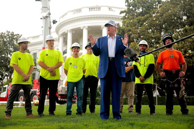 Chip Somodevilla/Getty  President Donald Trump with workers in front of the White House on June 18.