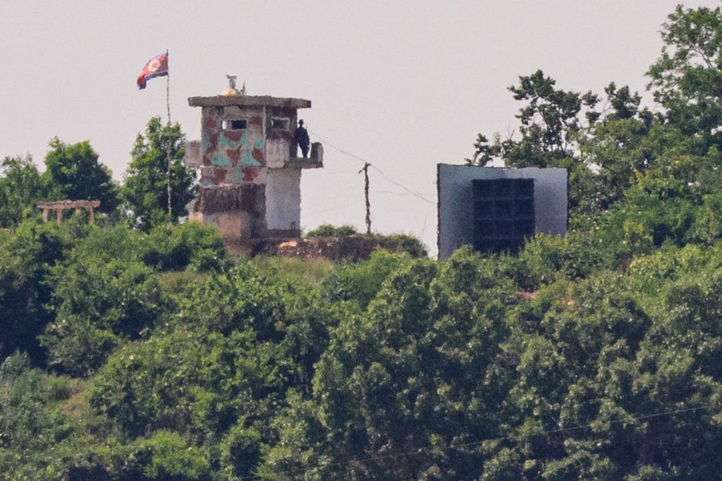 A North Korean soldier stands guard in a watchtower next to a giant loudspeaker (right) near the demilitarised zone dividing the two Koreas on June 12. Photo: AFP