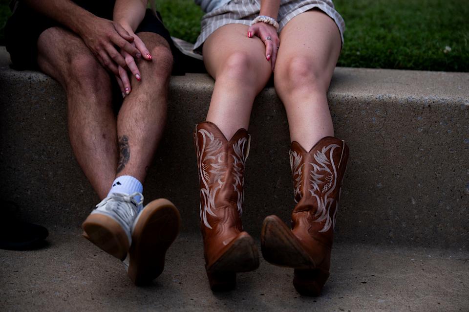 Nick Boule and Brielle Gregorio hold hands as Jackson Dean performs on the third day of CMA Fest in Nashville, Tenn., Saturday, June 7, 2025.