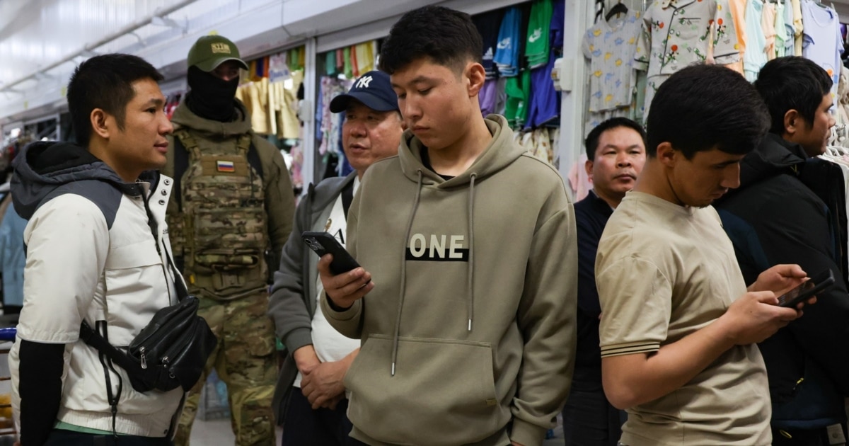 Russia's Migrant Crackdown Expands With Mandatory Mobile Tracking
