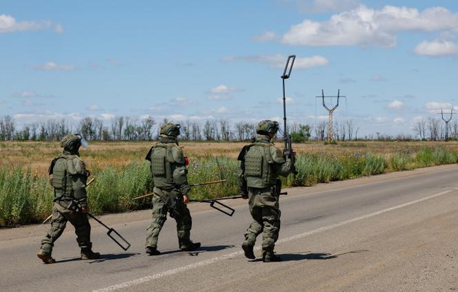 Sappers of the Russian armed forces walk along a motorway as they search for explosives and demine an area near the town of Marinka (Maryinka) in the Donetsk region, a Russian-controlled territory of Ukraine, June 24, 2025.