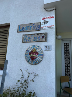 a sign reading Learning Refuge next to a doorway