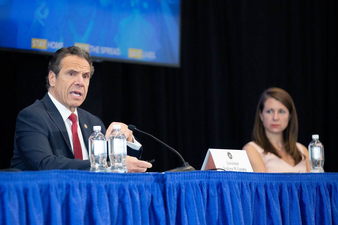 Melissa DeRosa, then the secretary to the governor, right, listens as then-Gov. Cuomo speaks during his daily coronavirus press briefing on April 28, 2020, in Syracuse, New York.