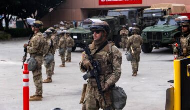 National Guard troops stand outside the Metropolitan Detention Center on Sunday in Los Angeles. Tensions in the city remain high after the Trump administration called in the National Guard against the wishes of city leaders following two days of clashes with police during a series of immigration raids.