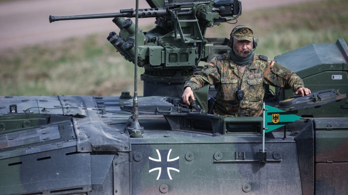 A soldier in a German armoured fighting vehicle during military exercises