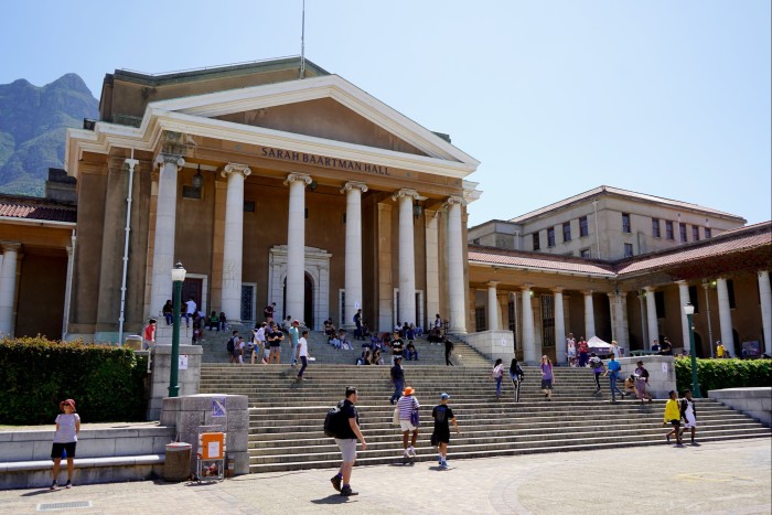 A city building with steps leading up to a classical portico