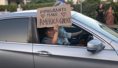 A woman holds a placard that says ‘Immigrants make America great’