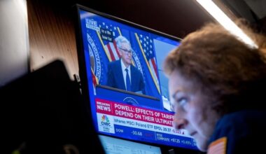 TV screen showing Fed chair Jay Powell speaking to media