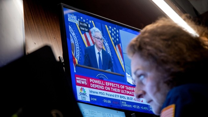 TV screen showing Fed chair Jay Powell speaking to media