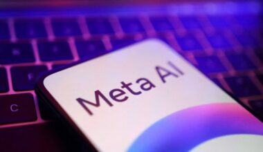 A Meta logo on a mobile phone with a computer keyboard in the background