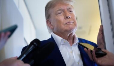 Donald Trump speaks to reporters aboard Air Force One