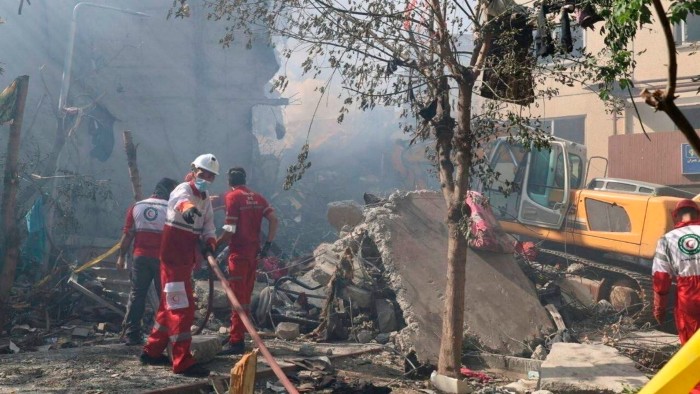 Rescuers work at the scene of an Israeli strike in Tehran