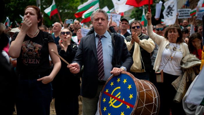 Protesters at an anti-euro rally in Sofia with one person beating a drum