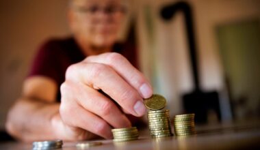 An old man counts money at home in Berlin